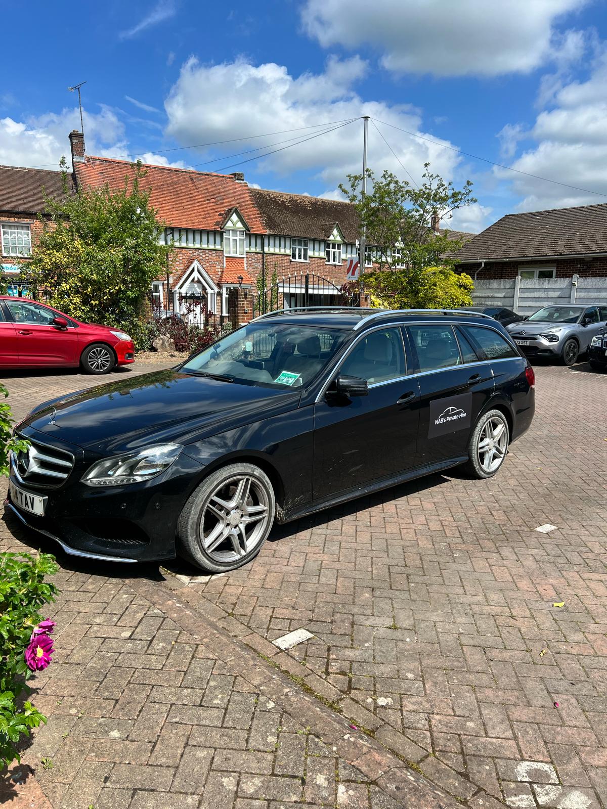 NABs Private Hire black Mercedes-Benz E-Class E350 kerbside in the Berkshire countryside